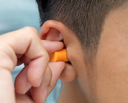 Put,Protective,Earplug,Into,The,Ear